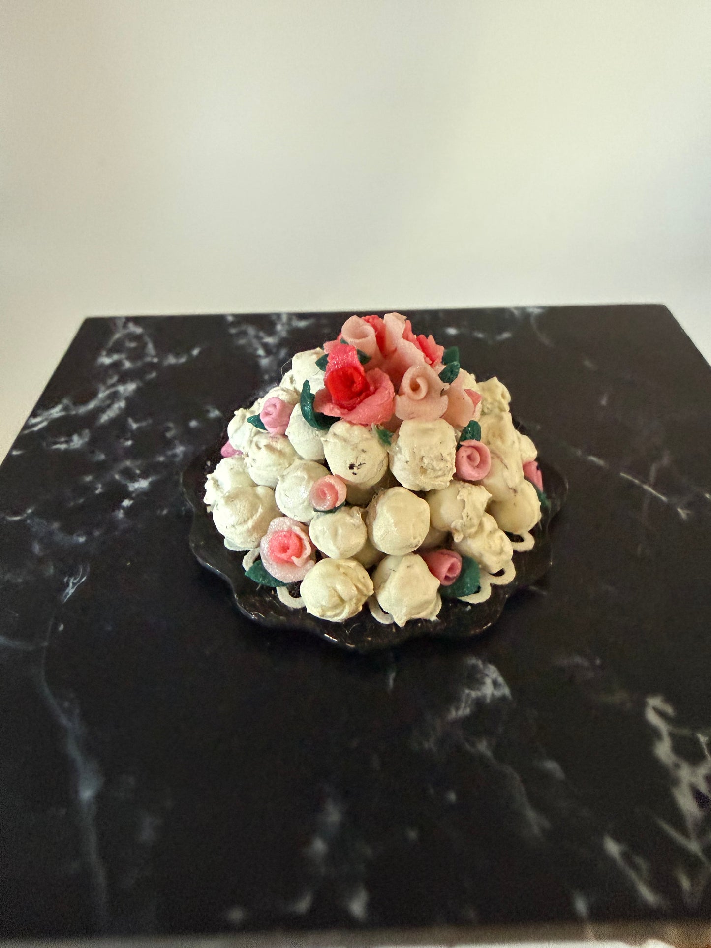 Stack of cream puffs with roses