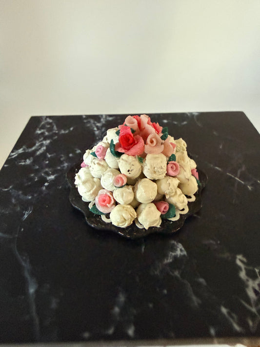 Stack of cream puffs with roses