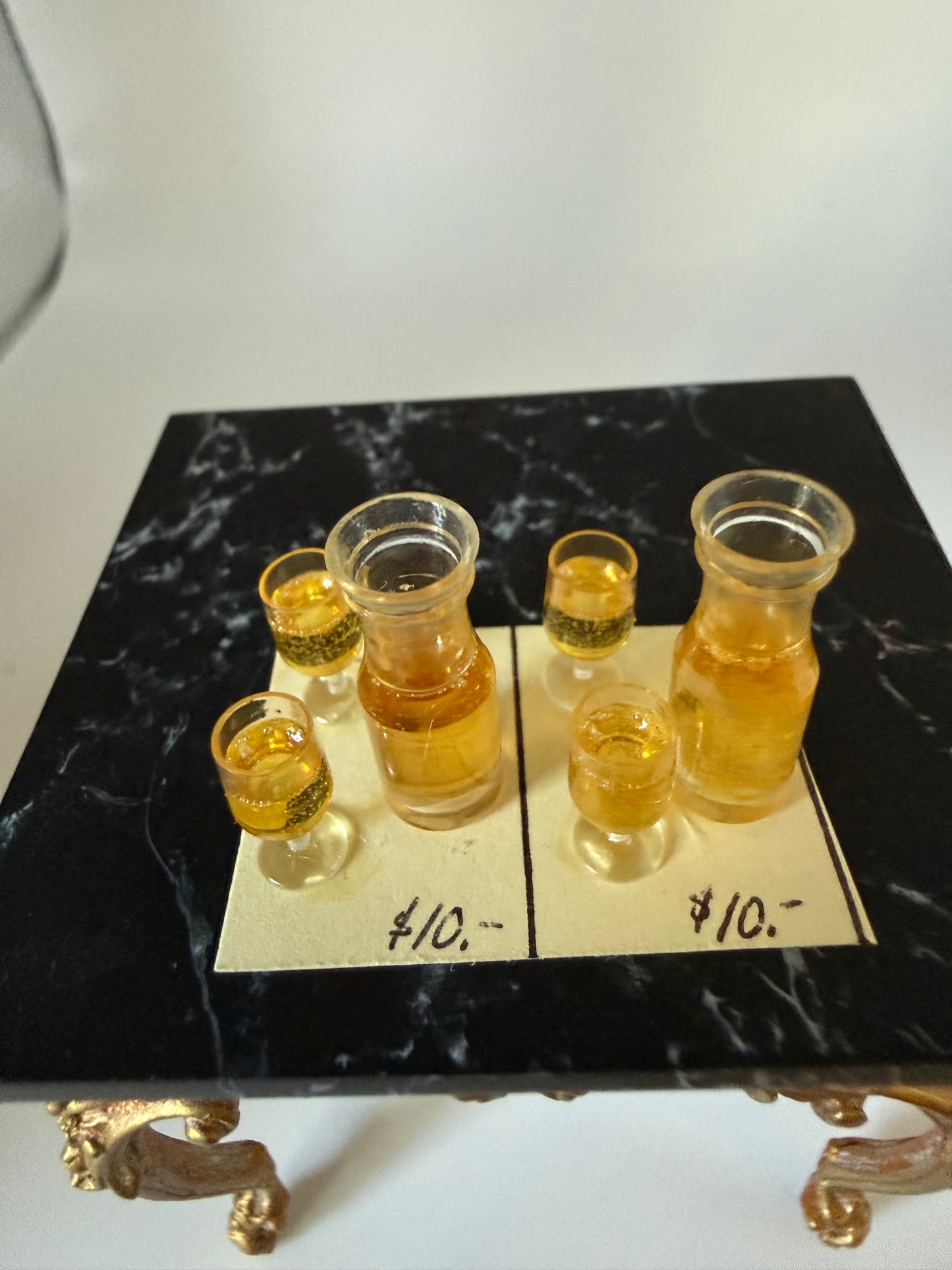 two sets of wine carafes with glasses